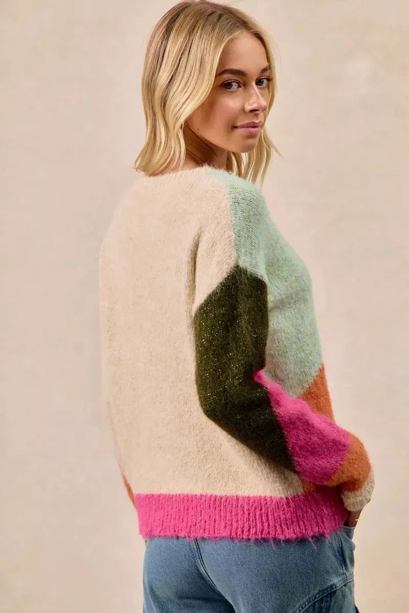 Back view of BiBi color block knit sweater on female model