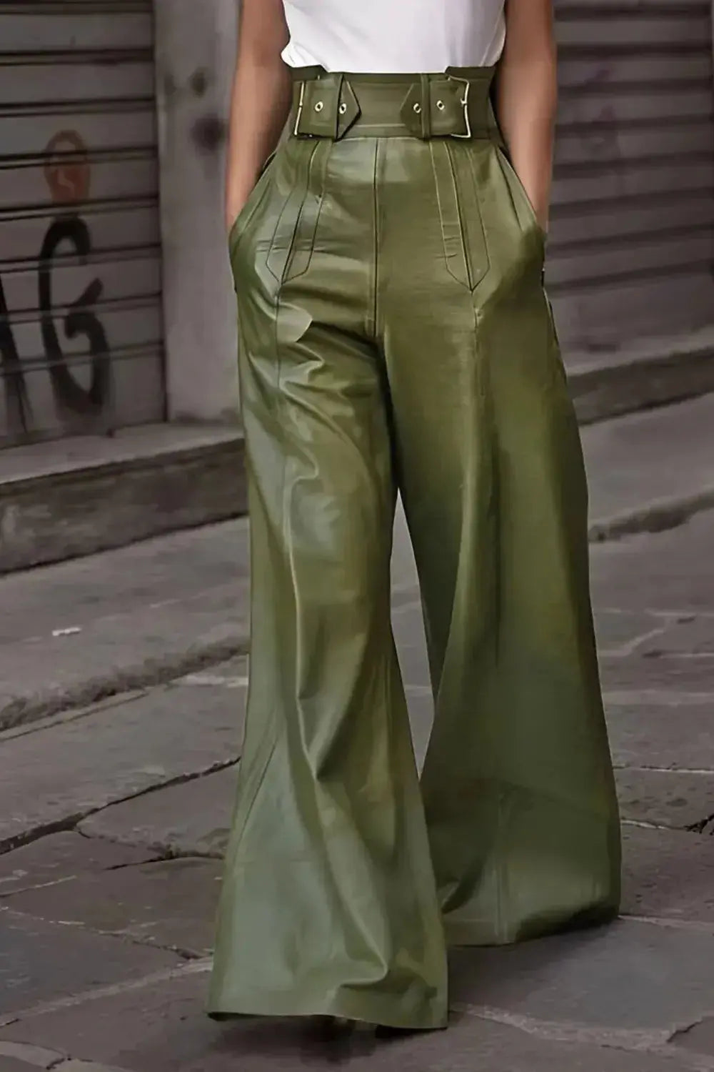 Front view of green faux leather high waist wide leg pants styled with white top.