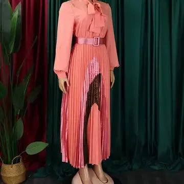  Side view of pleated Pink midi dress on display.

