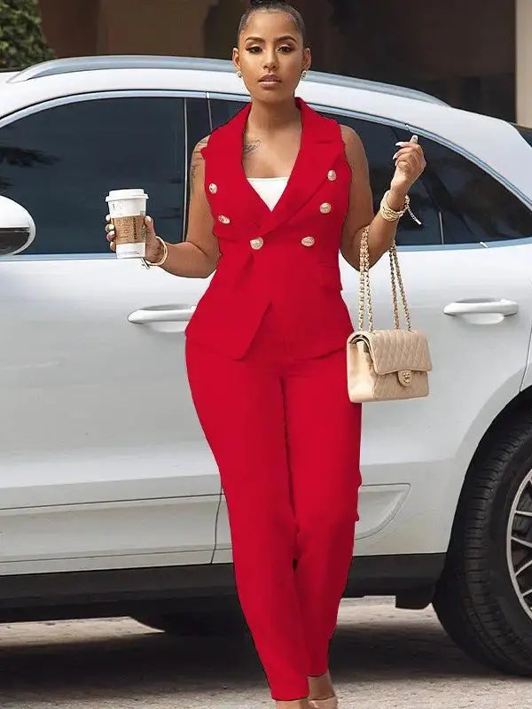 Woman in red double-breasted blazer tank and matching tapered pants walking confidently.