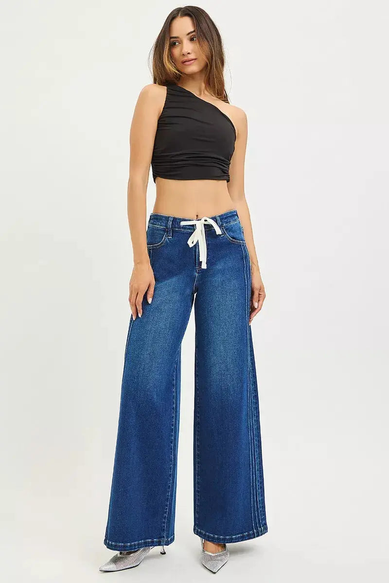 Model showcasing RISEN wide leg jeans – styled outfit