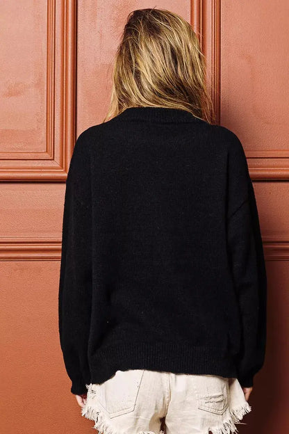 Side pose of festive embroidered Christmas sweater.