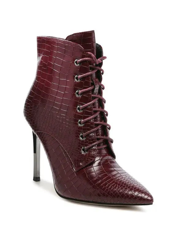 Burgundy croc-embossed lace-up stiletto boot with pointed toe and high heel.