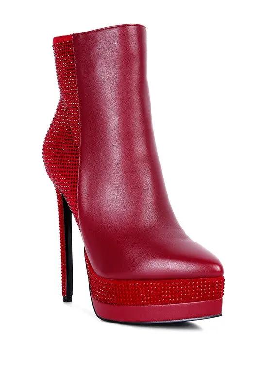 Red platform ankle boots with sleek pointed toe and tall stiletto heel.
