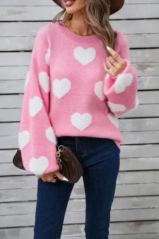 Fuzzy knit heart sweater for women in soft pink - front view on female model.