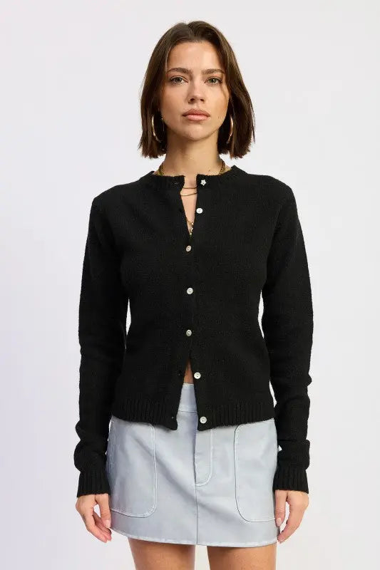 Fitted button up cardigan for women in black styled with mini skirt front view
