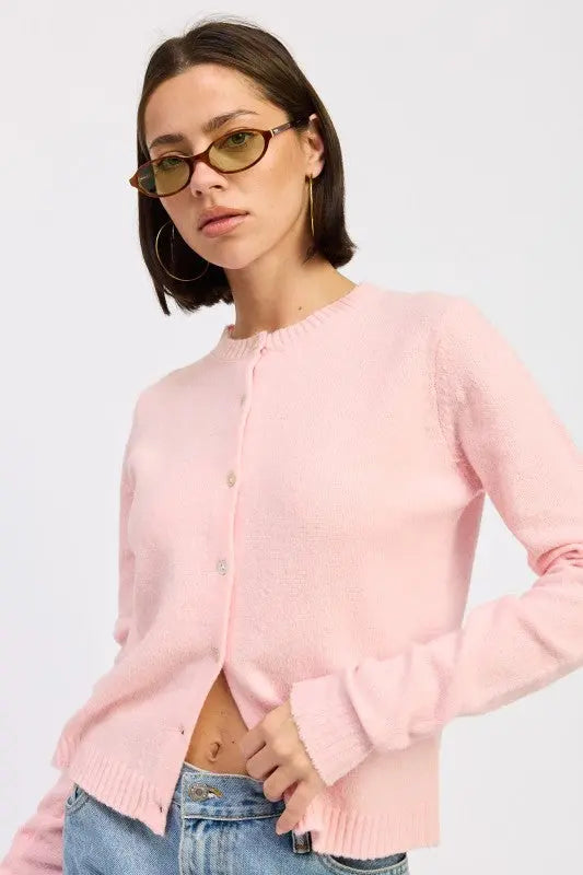 Color option: light pink fitted button up cardigan on female model - slanted pose.