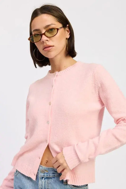 Color option: light pink fitted button up cardigan on female model - slanted pose.