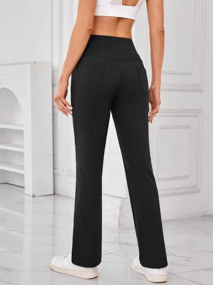 Woman wearing black high-waisted active pants with pockets by JupiterGear - back view