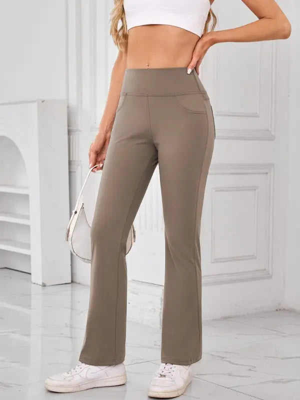 Woman wearing camel high-waisted active pants with pockets by JupiterGear - front view