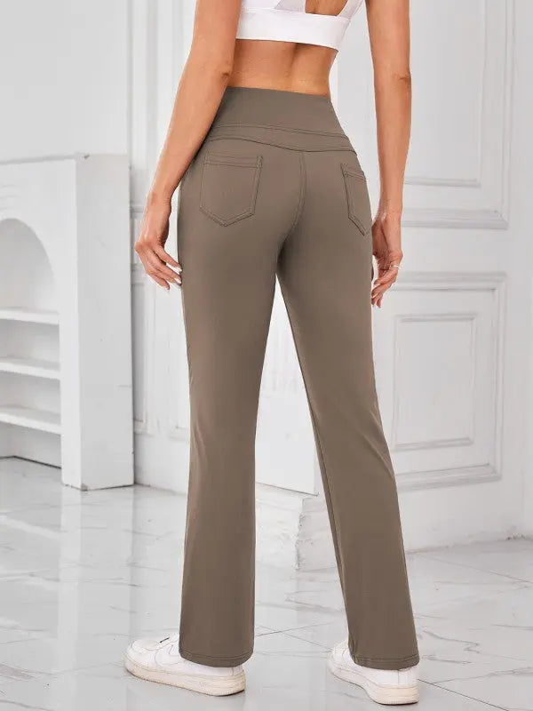 Woman wearing camel high-waisted active pants with pockets by JupiterGear - back view