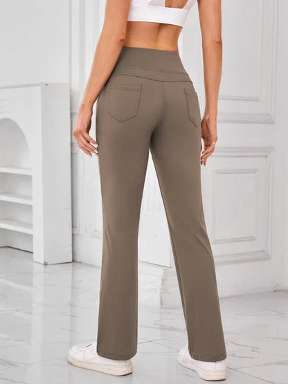 Woman wearing camel high-waisted active pants with pockets by JupiterGear - back view