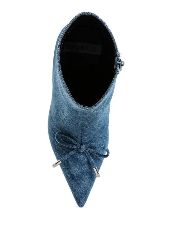 Top-down angle of pointed toe denim stiletto boots.