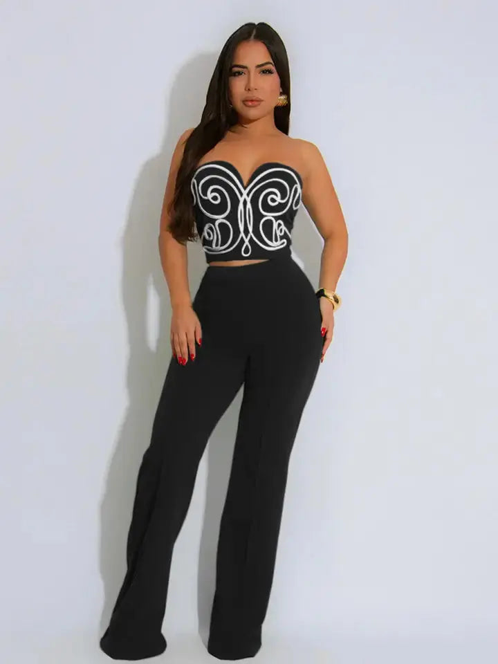 Woman wearing black strapless crop top two-piece set