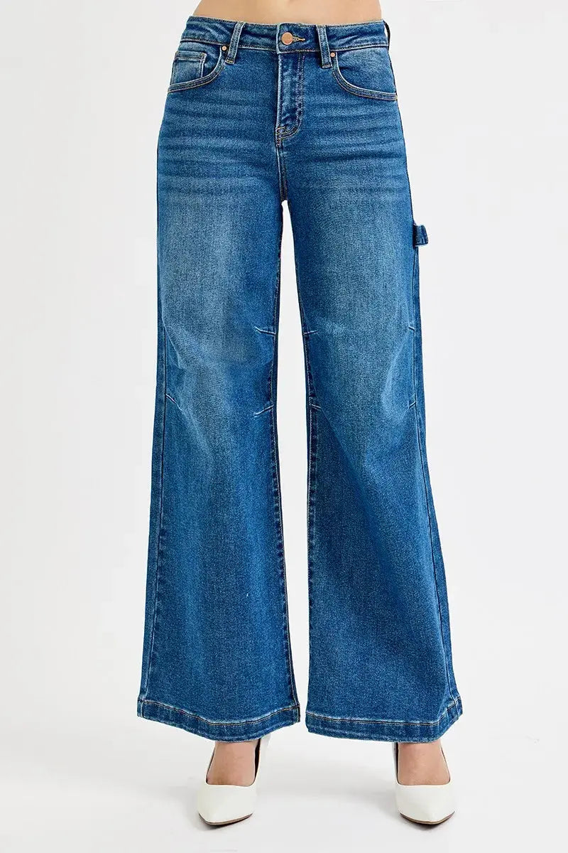Plus size model wearing high-rise wide-leg patch detailed denim jeans (front view).