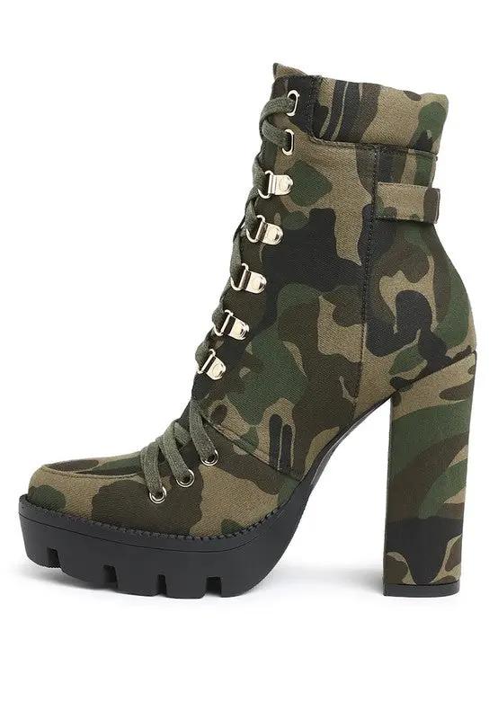 Angled shot showing metallic buckle and lace-up detail on camo ankle boots.
