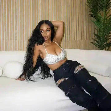 Woman model wearing black Distressed Wash Cargo Jeans while posing on white couch Couture Envy