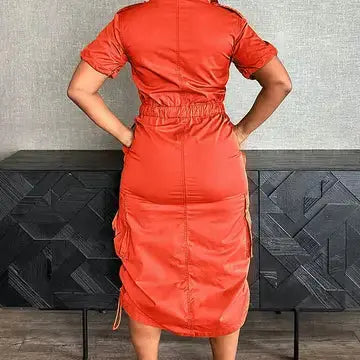 Back view of orange cinched waist utility shirt dress.