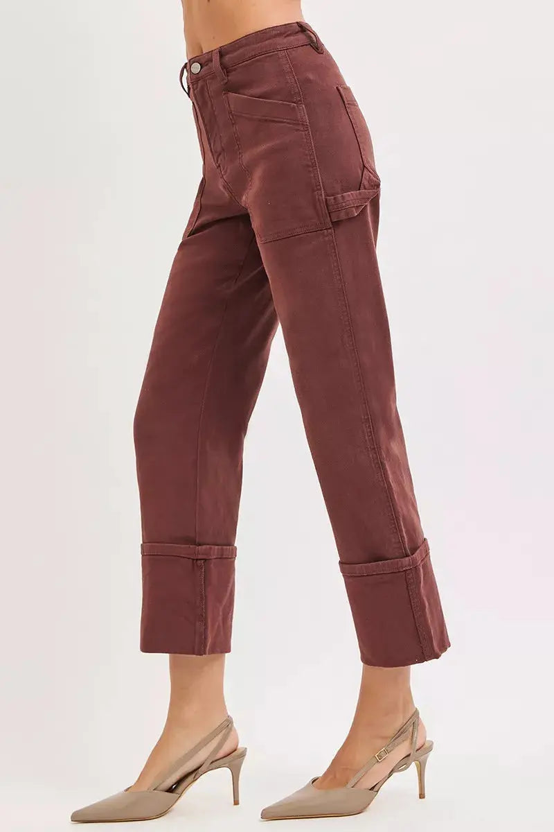 Side view of burgundy wide-leg cuffed jeans with carpenter pocket detailing