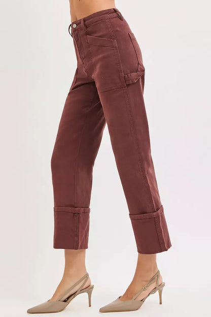 Side view of burgundy wide-leg cuffed jeans with carpenter pocket detailing