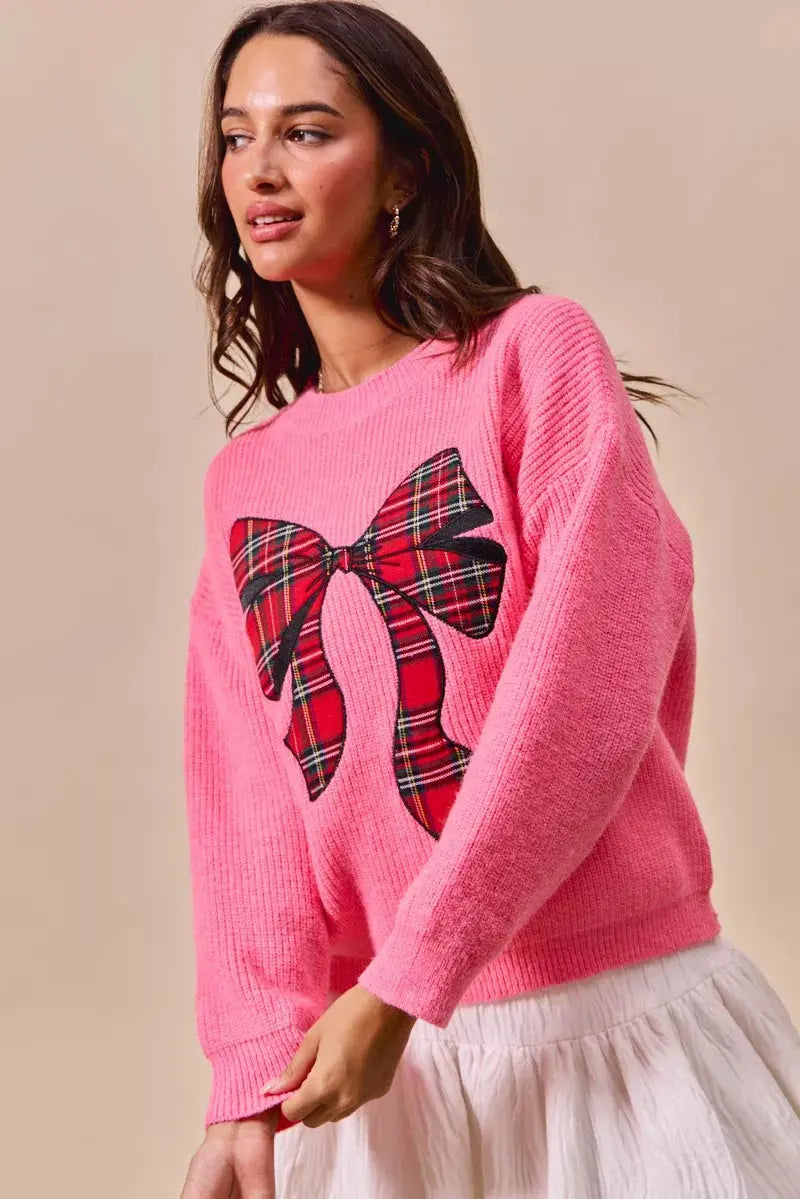 Pink checker plaid ribbon Christmas sweater styled with skirt.