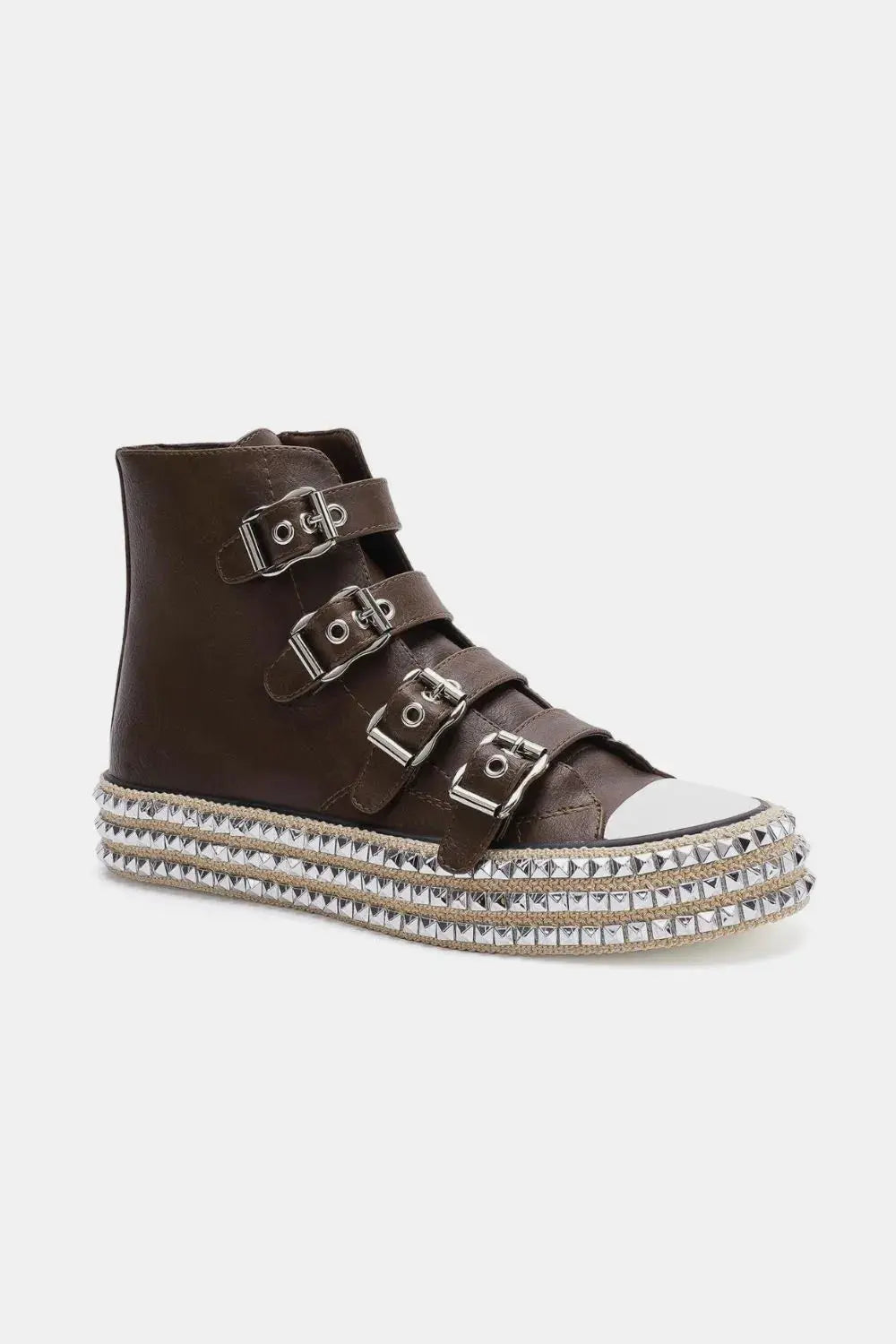 Front view of buckle straps and metal studs on platform sneakers