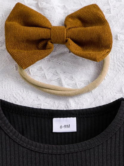 Flat lay of toddler girl ribbed long sleeve top and bow skirt outfit with headband.