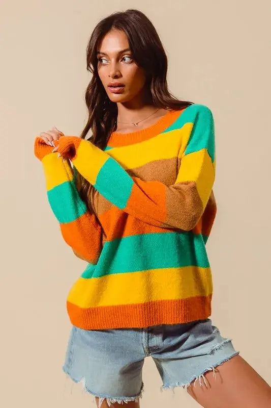 Playful pose showing full-length fit of striped sweater