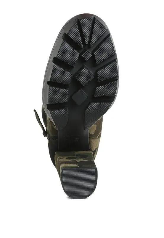 Bottom view showing treaded sole of camo ankle boots for women.