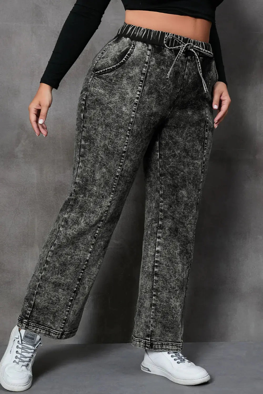 Side angle of women’s plus size straight leg jeans with drawstring waist.