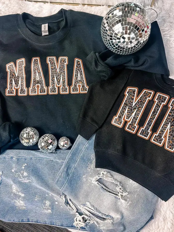 Mama and Mini leopard print matching sweatshirts displayed with denim and disco balls.