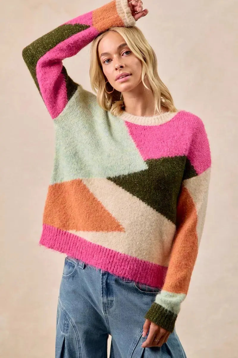 Model wearing multi color block sweater in pink and neutral tones