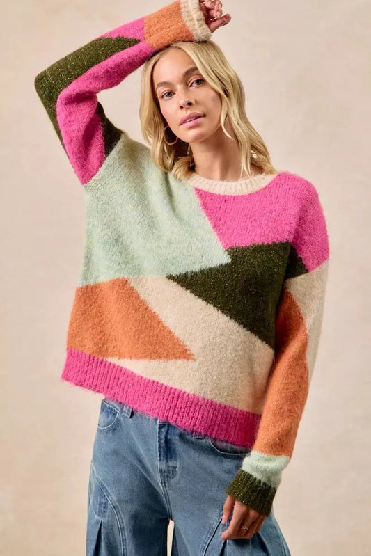 Model wearing multi color block sweater in pink and neutral tones
