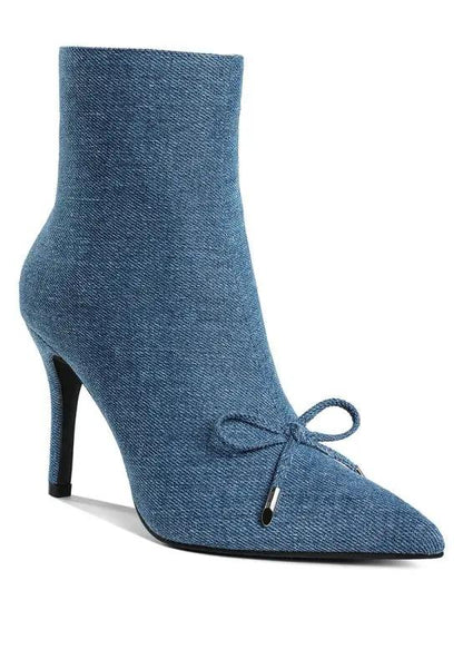 Front view of denim stiletto boots with bow detail and pointed toe.