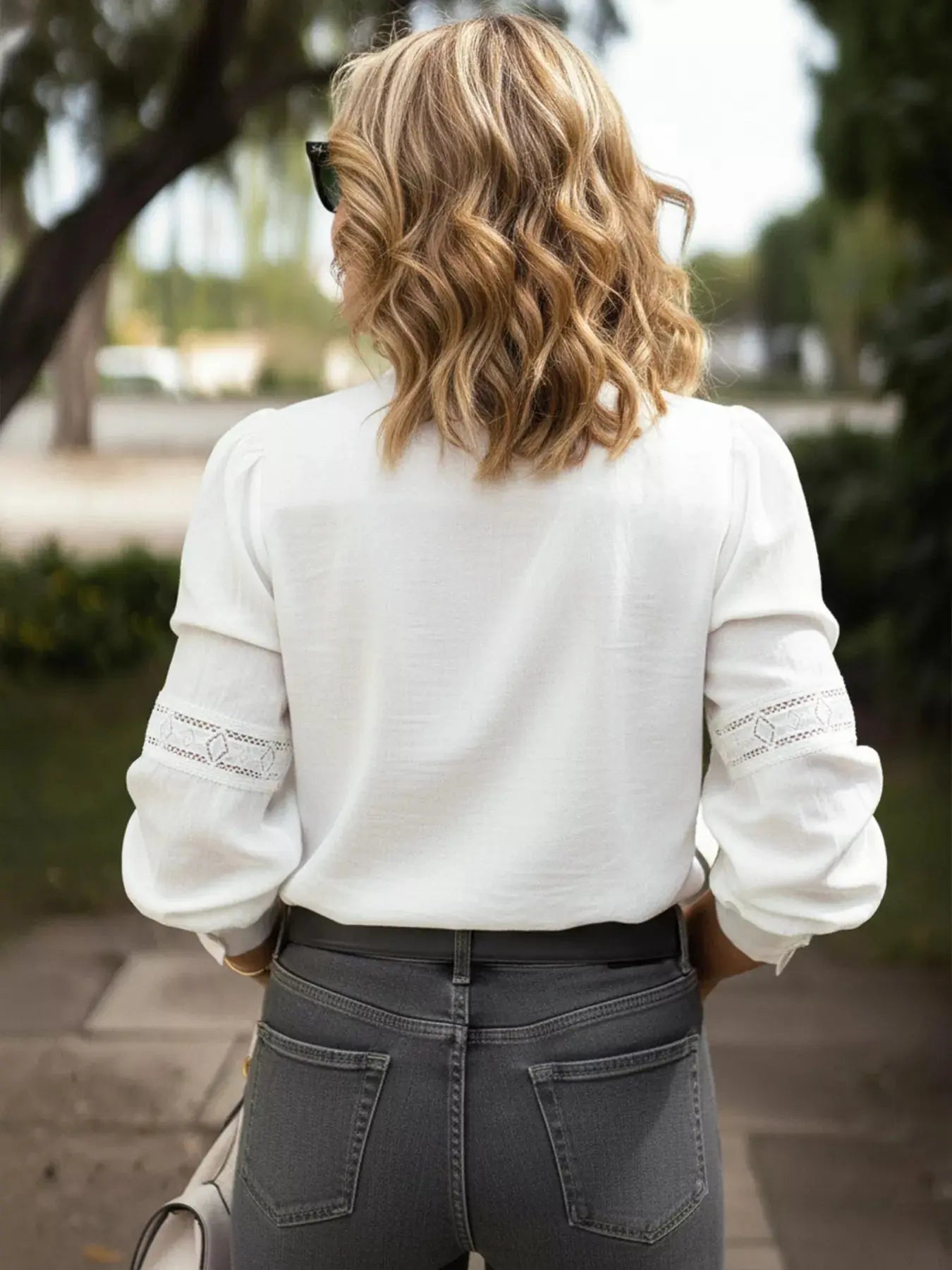 Women’s lace trim long sleeve shirt in elegant white - back view.