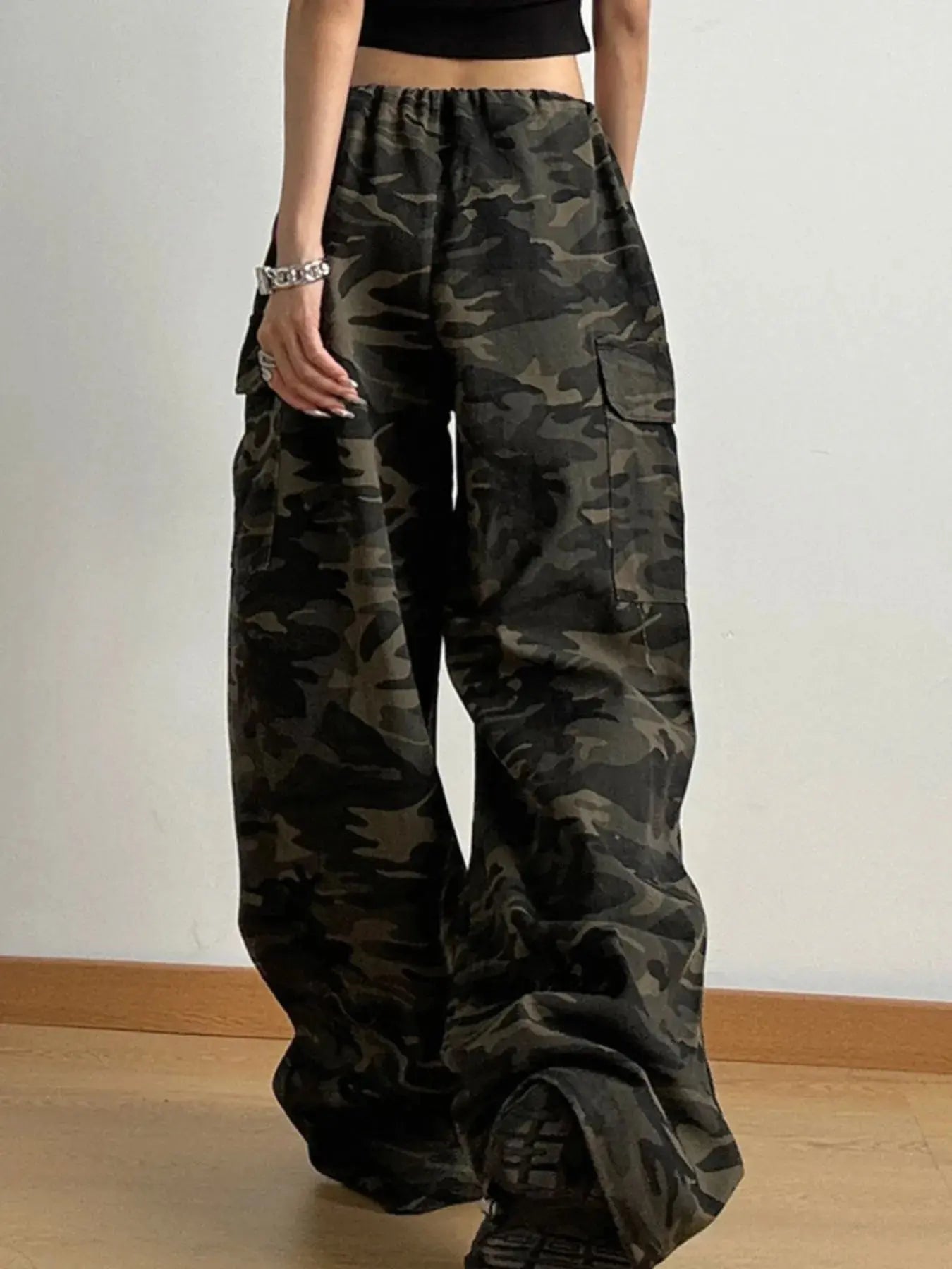 Back view of women’s camouflage drawstring cargo jeans with loose fit.