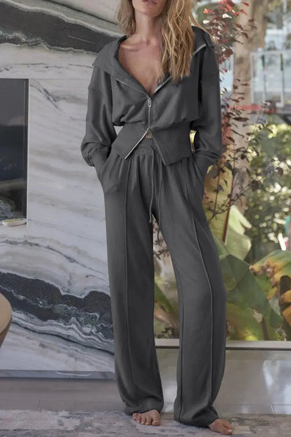 Woman wearing gray zip-up hoodie and wide leg pants active set.