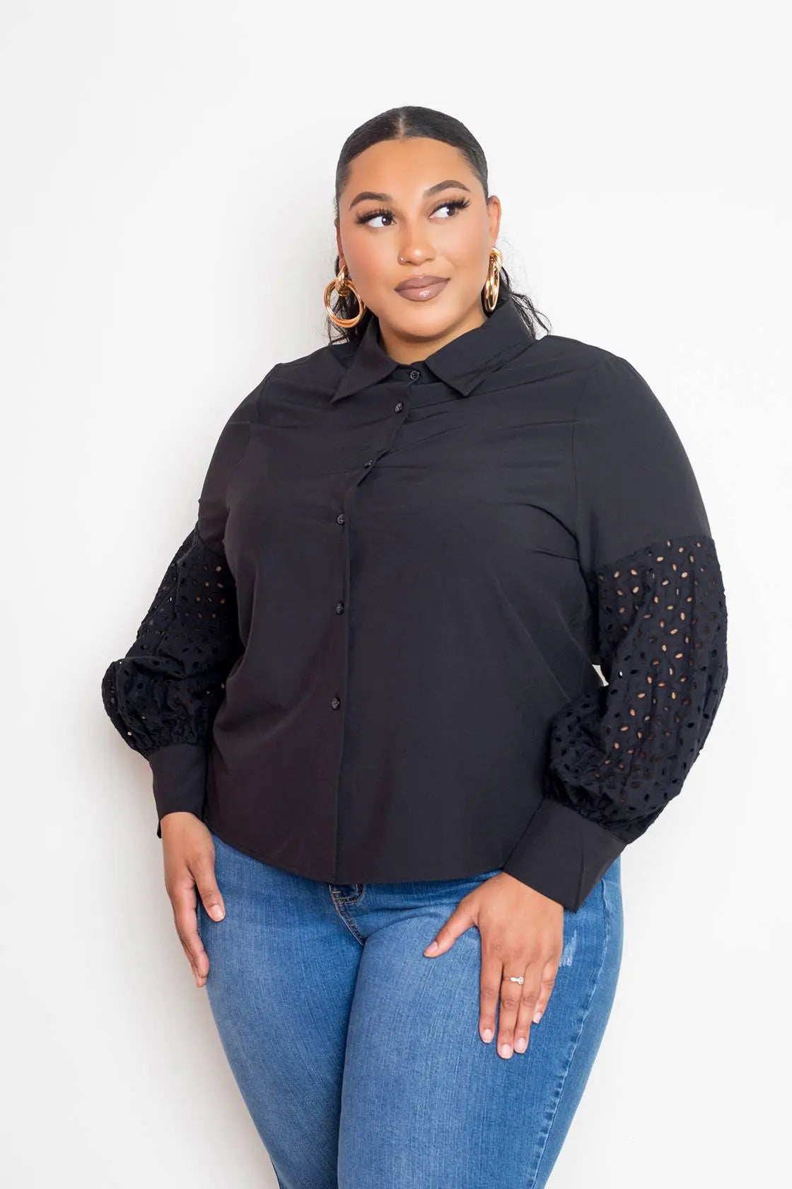 Plus size black blouse with punched sleeves front view on female model posing 