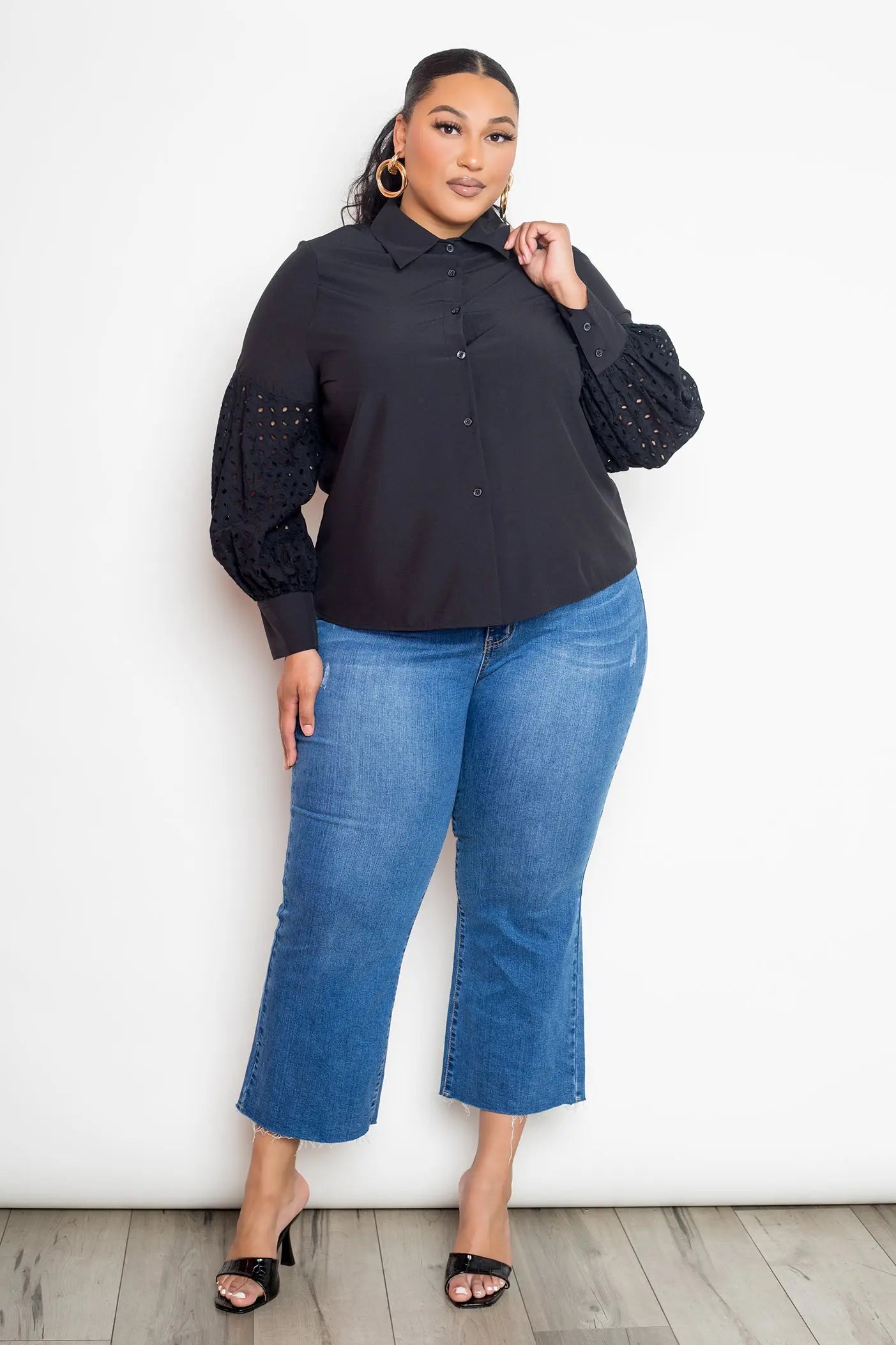Plus size everyday black blouse styled casually on female model