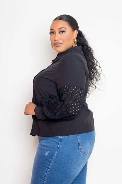 Curvy model wearing black punched sleeve blouse side angle