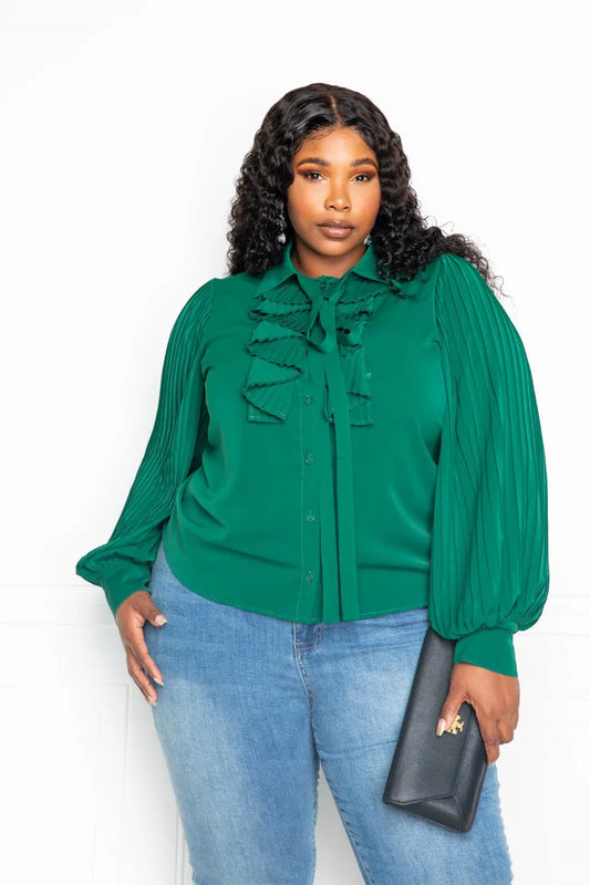 Woman wearing green pleated sleeve blouse with waterfall frill and bow – front view