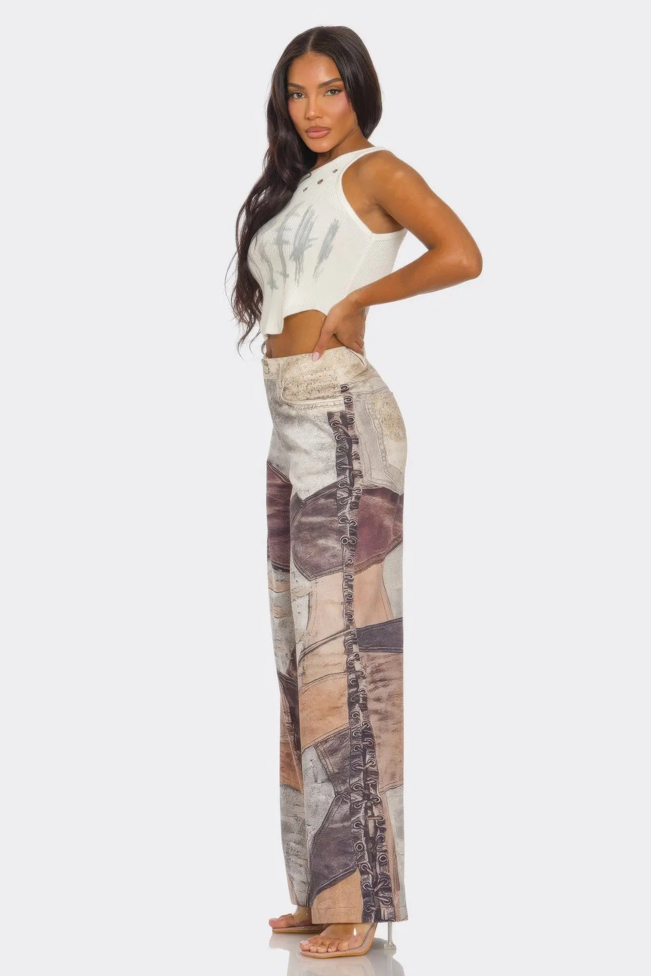 Side view of bold fabric printed pants in orange, brown, and cream tones.