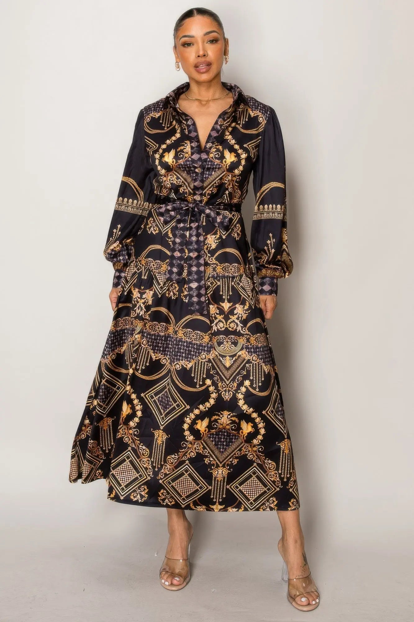 Front view of black and gold printed maxi dress with flowy fit.