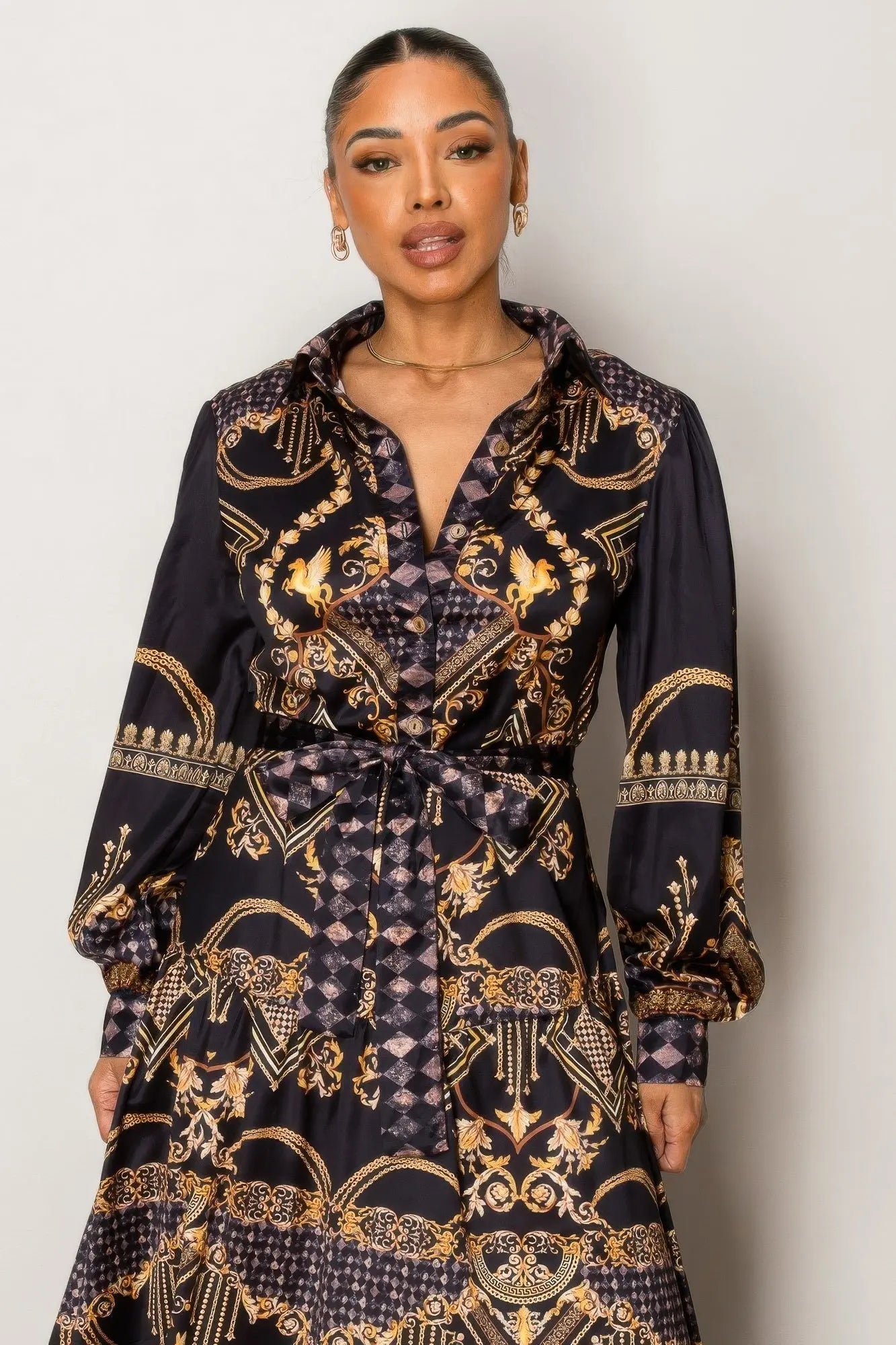 Full-length black and gold maxi dress styled with heels.