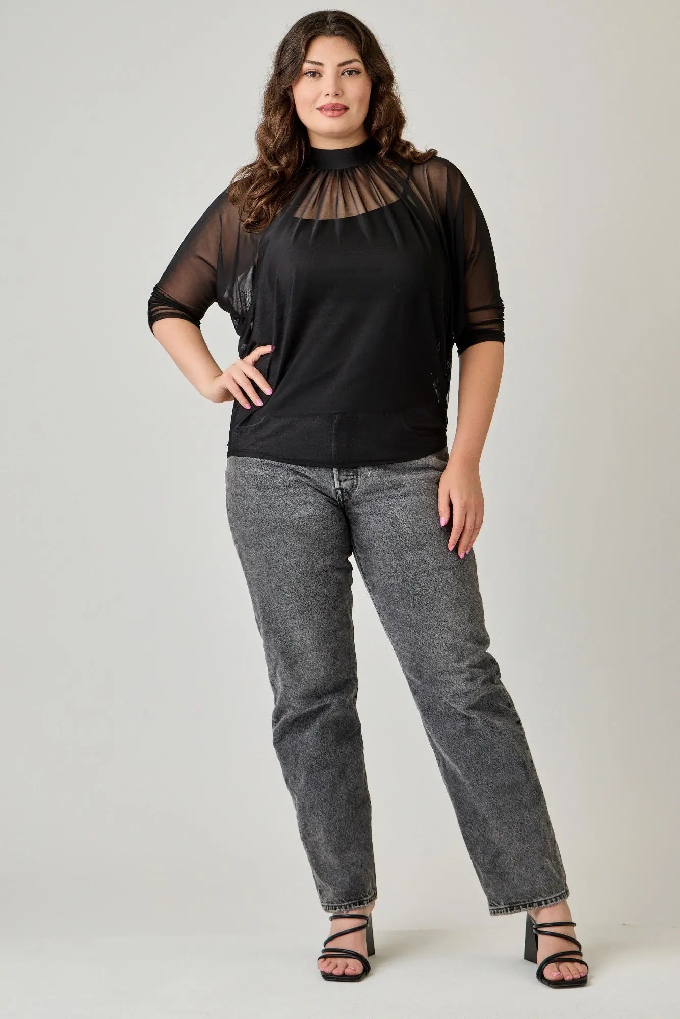 Plus size elegant black mesh blouse lifestyle shot on female model