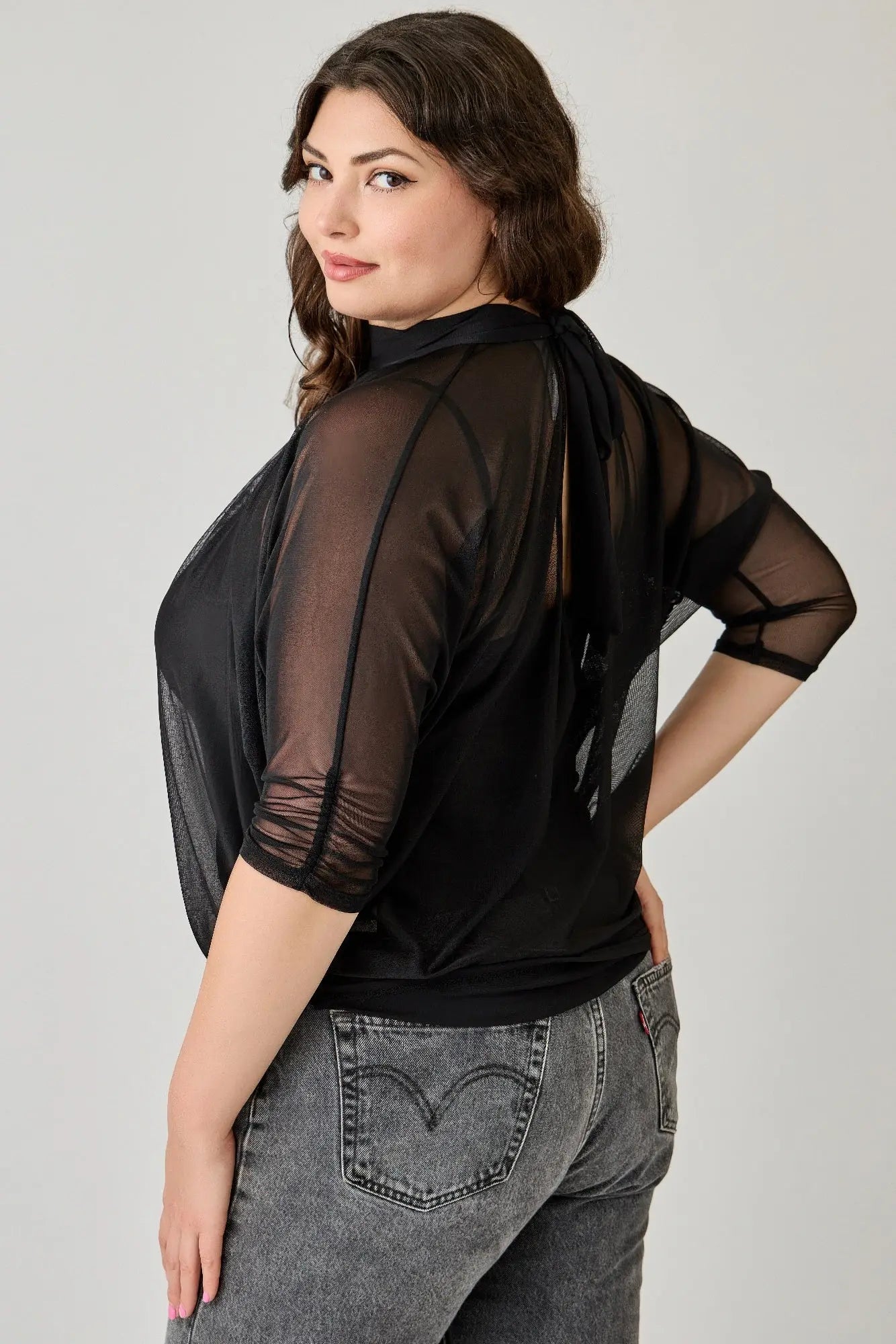 Plus size black mesh overlay blouse relaxed fit - back view on female model