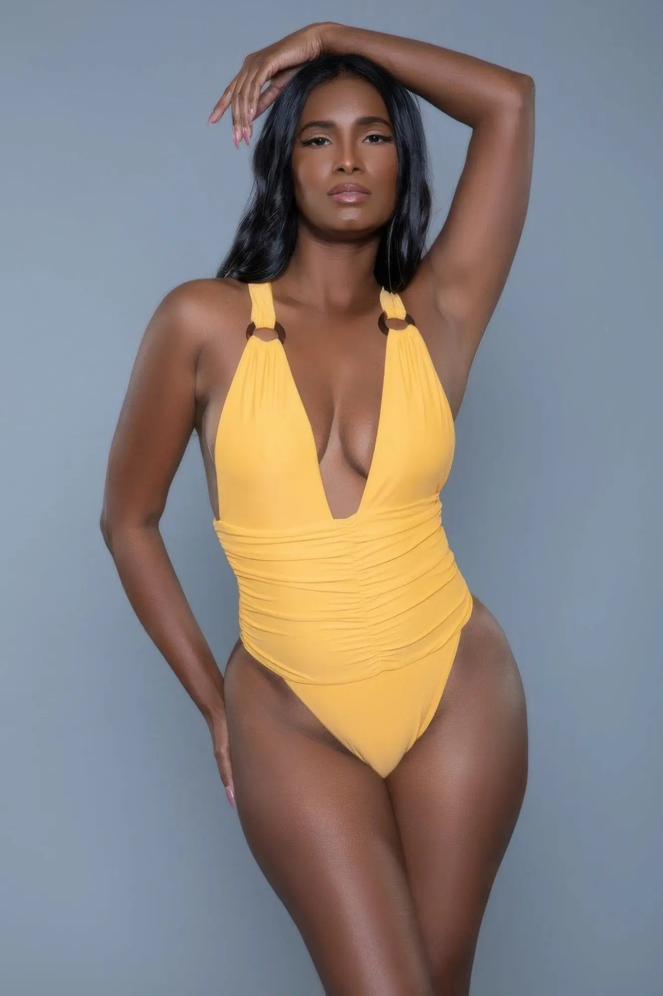 Ruched bodice one piece resort swimwear model pose