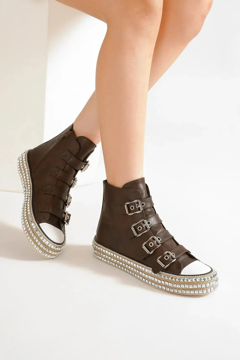 Front view of studded platform sneakers on model.