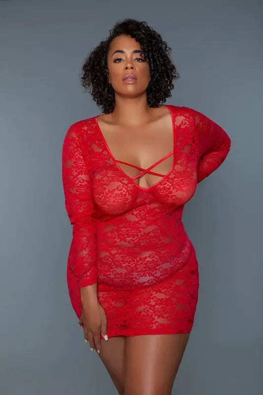 Plus size model wearing  lace chemise with deep V neckline and crisscross straps in red