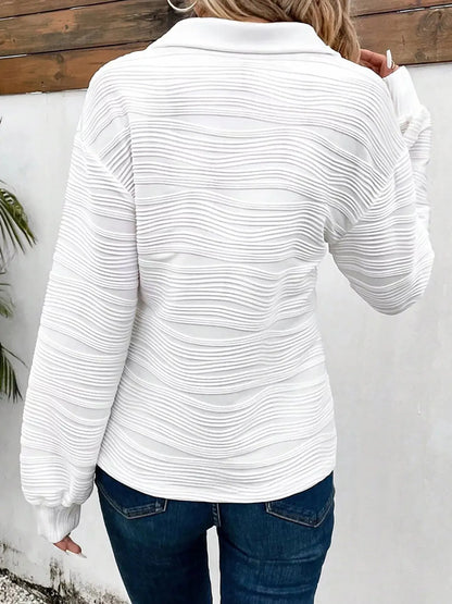 Back view of women wearing quarter zip sweatshirt in casual outfit.